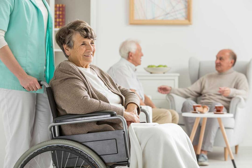 Resident reviewing a care plan with an assisted living staff member at a table.